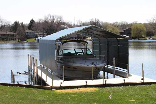 Custom-built boathouse with green on Lake Minnetonka offering boat protection and lakeside beauty