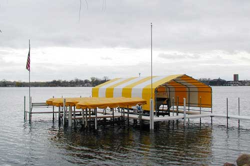 Custom-built boathouse with polydock on Lake Minnetonka offering boat protection and lakeside beauty