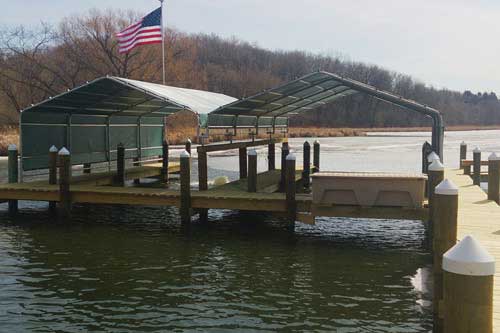 Custom-built boathouses with pilingdock on Lake Minnetonka offering boat protection and lakeside beauty
